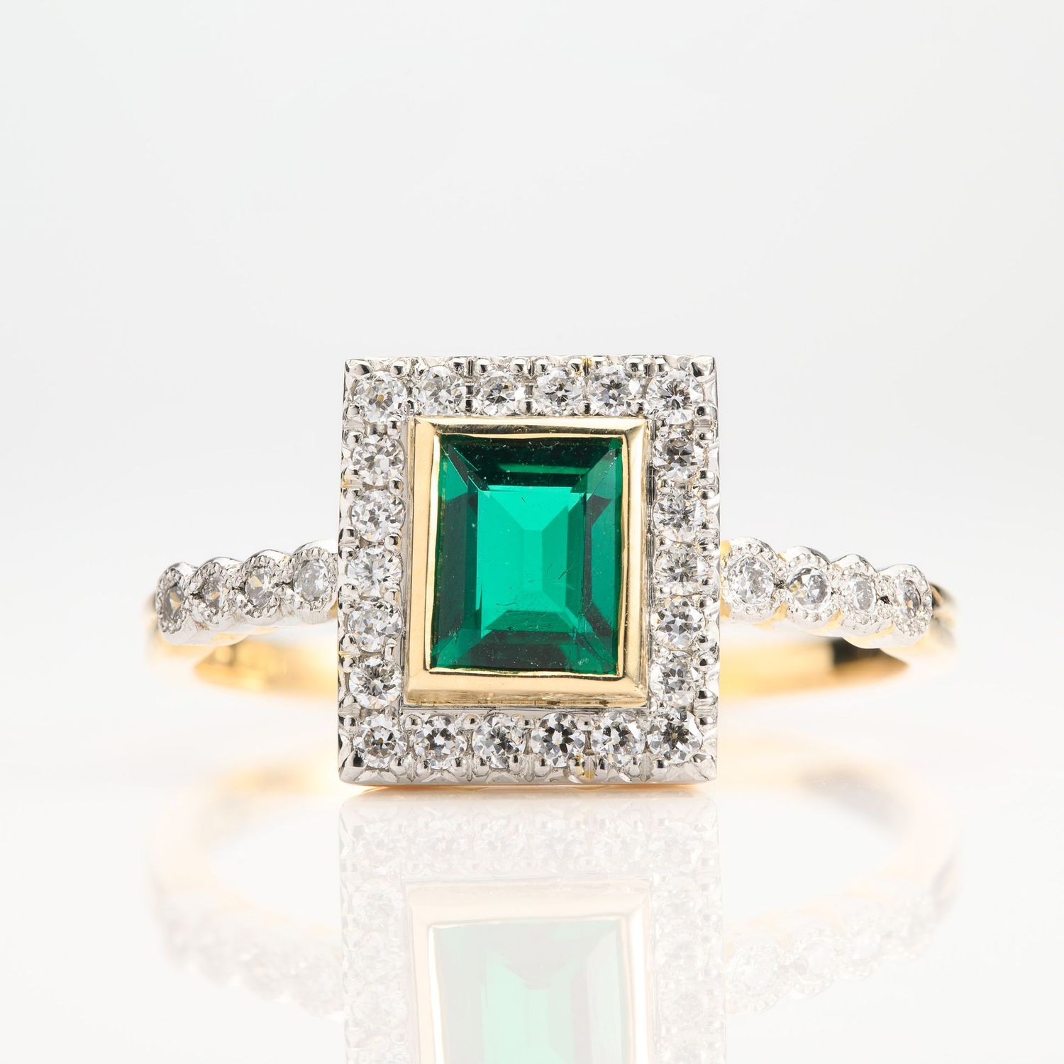 18ct Yellow Gold & Platinum Rectangular Cut Emerald & Round Brilliant Cut Diamond Halo Cluster Ring