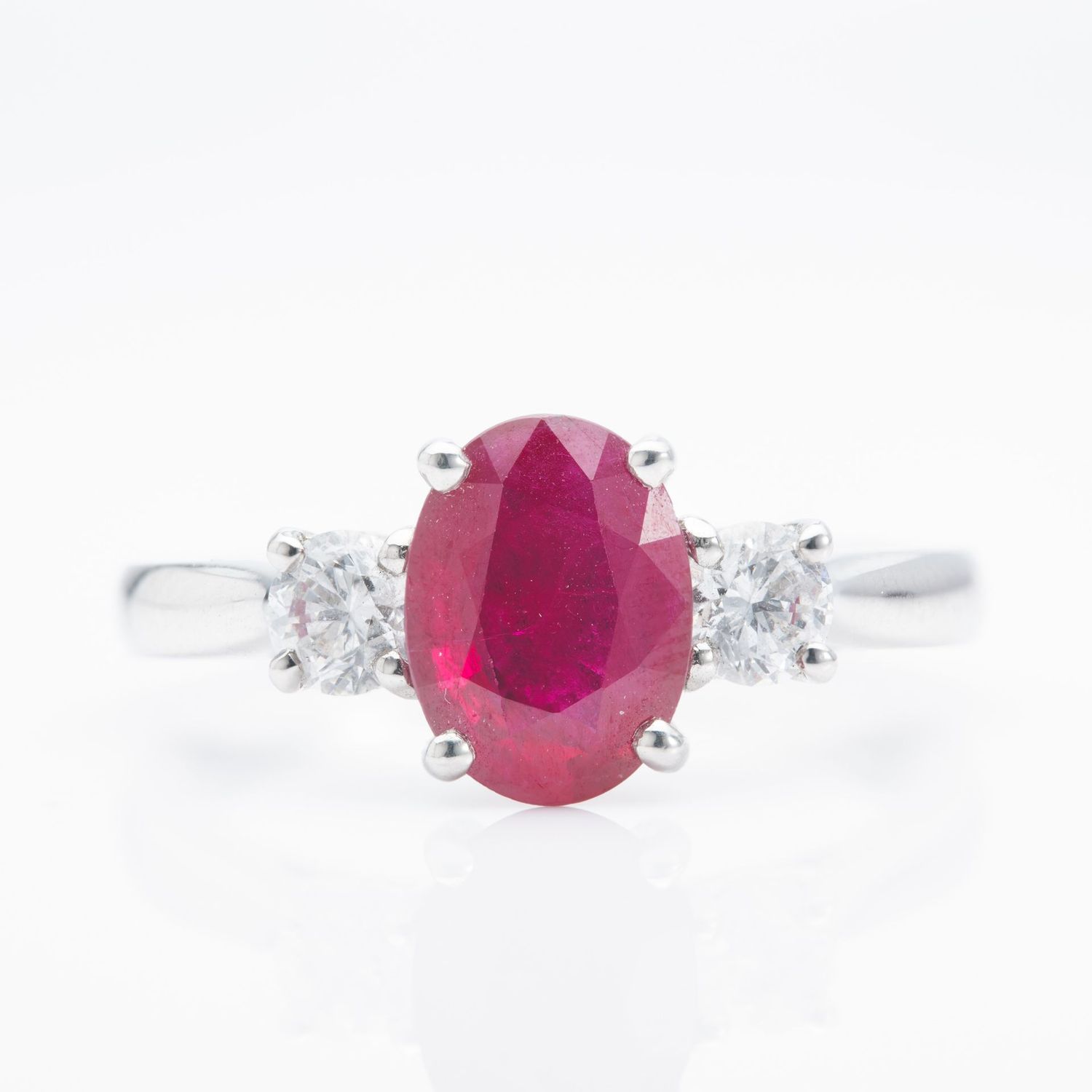 Platinum Oval Cut Ruby and Round Brilliant Cut Diamond Trilogy Ring