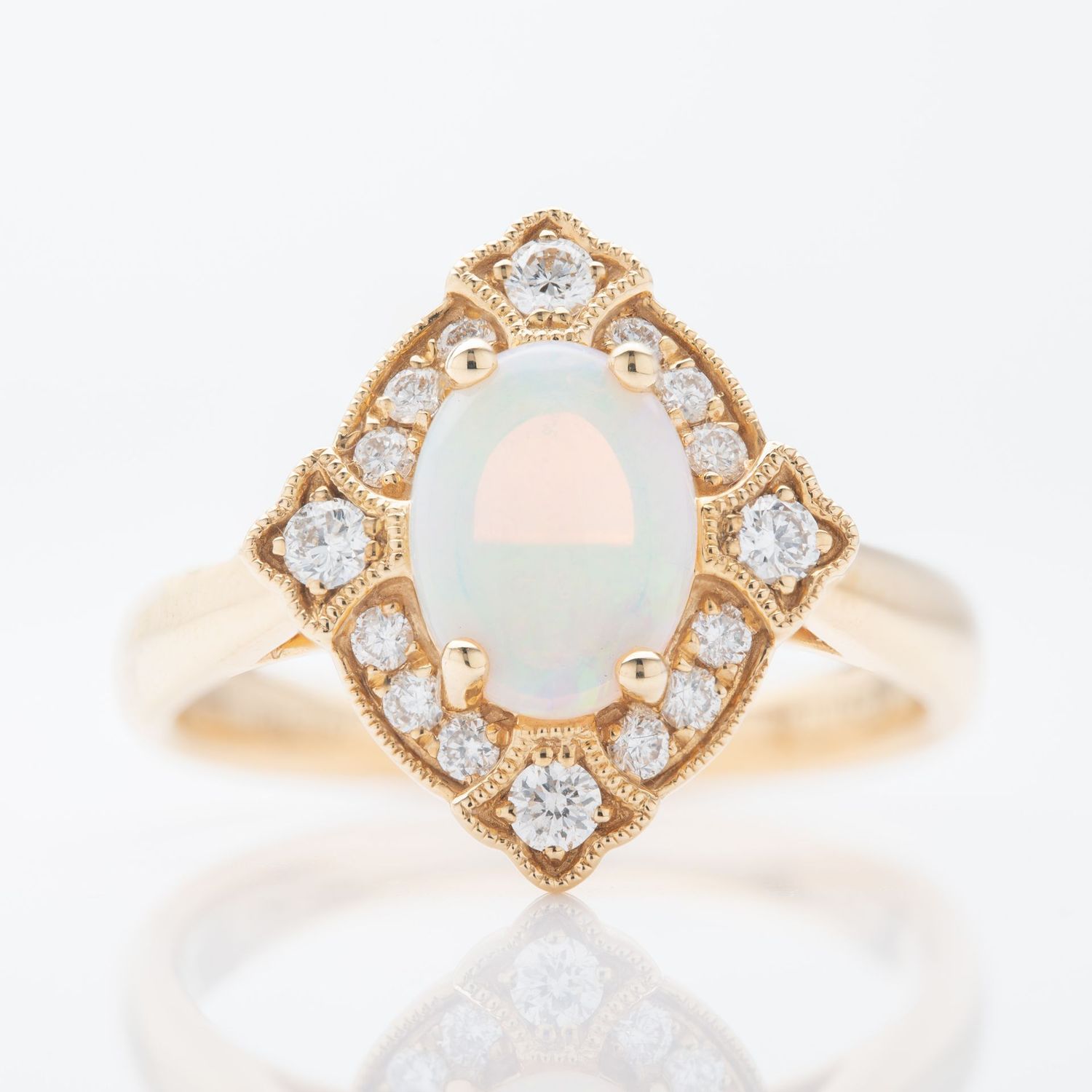18ct Yellow Gold Oval Cut Opal and Brilliant Cut Diamond Vintage Ring with Milgrain finish 18ct Yellow Gold Oval Cut Opal and Brilliant Cut Diamond Vintage Ring with Milgrain finish