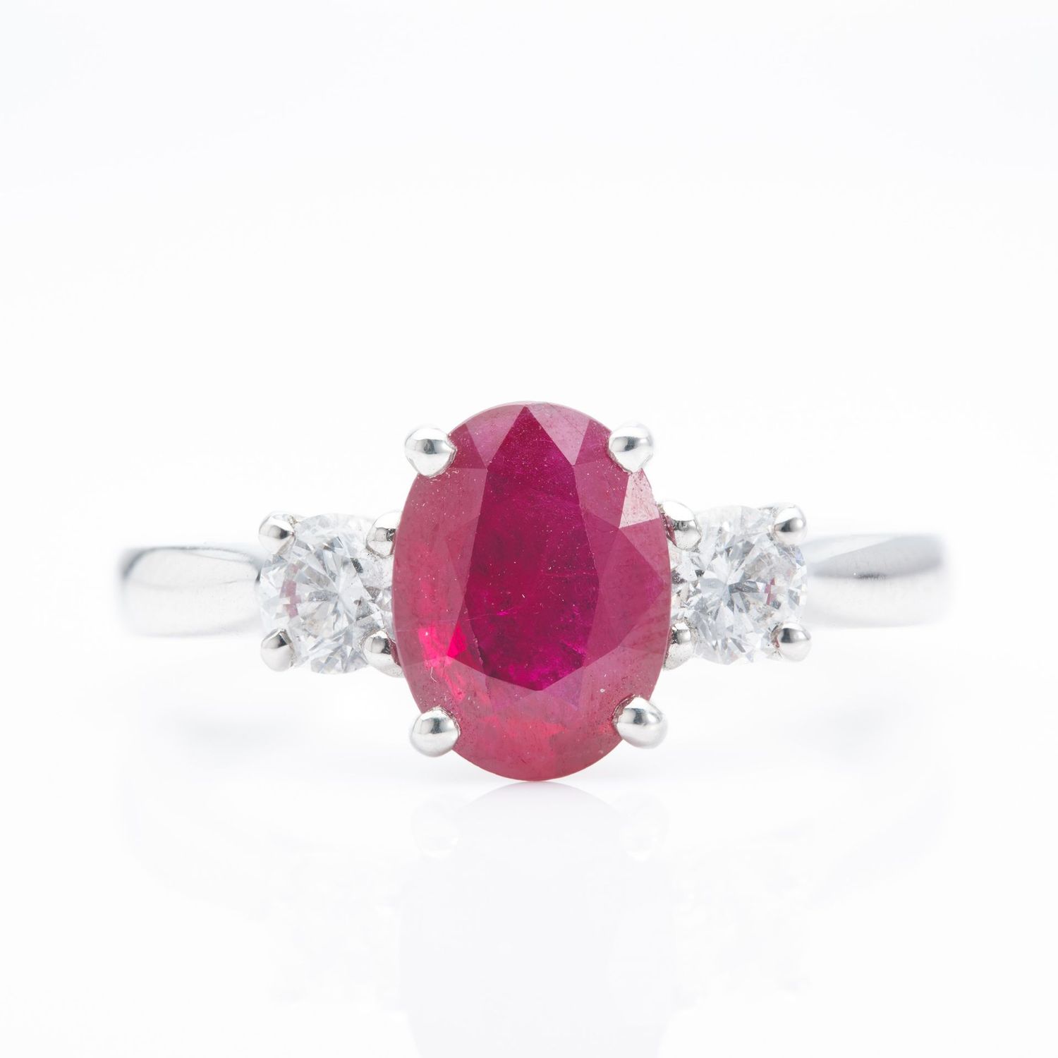 Platinum Oval Cut Ruby and Round Brilliant Cut Diamond Trilogy Ring