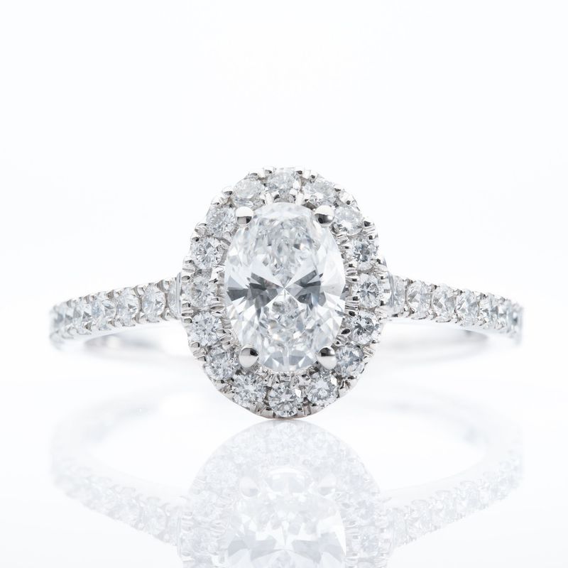 Platinum Oval and Brilliant Cut Diamond Halo Cluster Ring