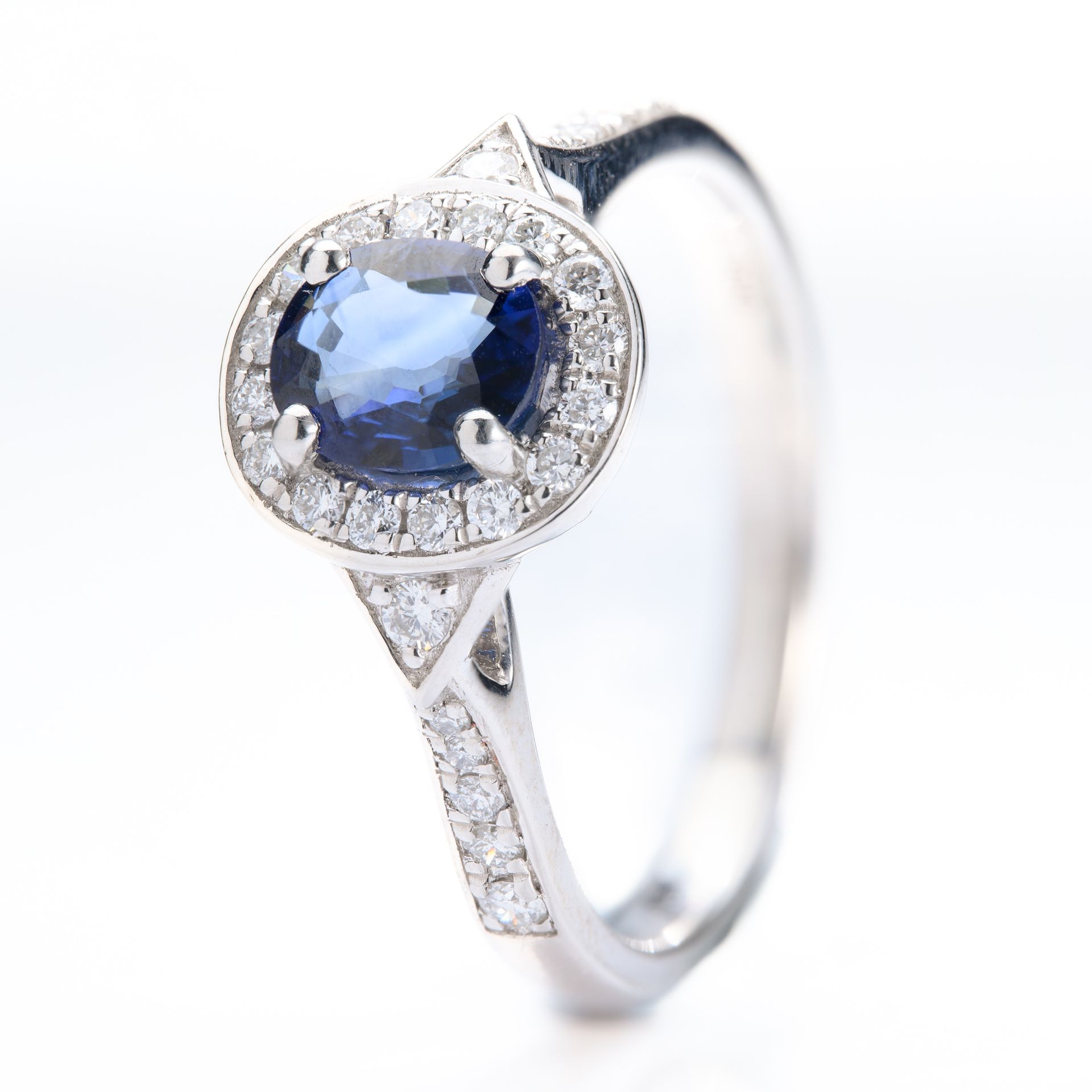 Platinum Oval Cut Sapphire & Round Brilliant Cut Diamond Halo Cluster Ring