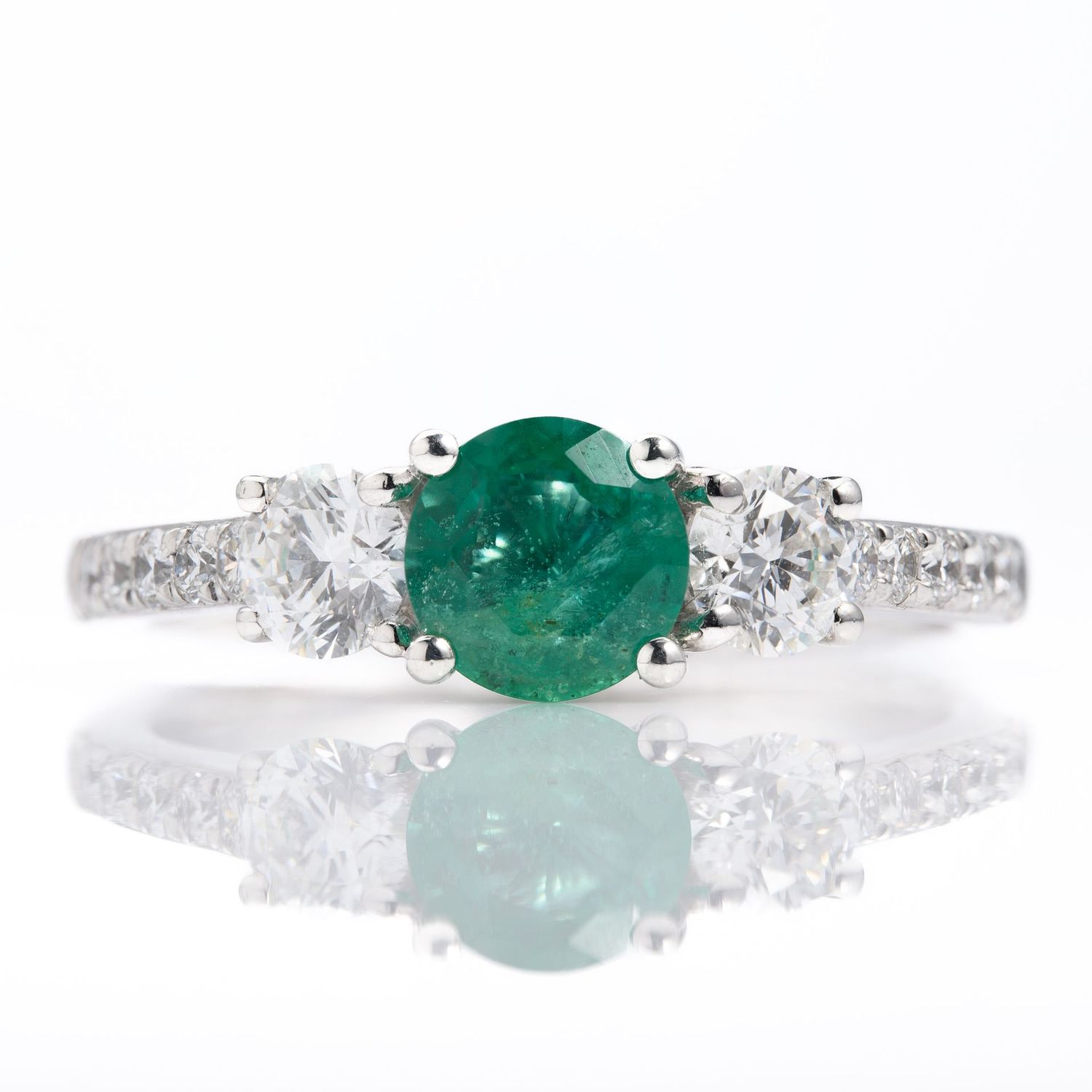 Platinum Round Cut Emerald & Round Brilliant Cut Diamond Trilogy Ring with Diamond Shoulders