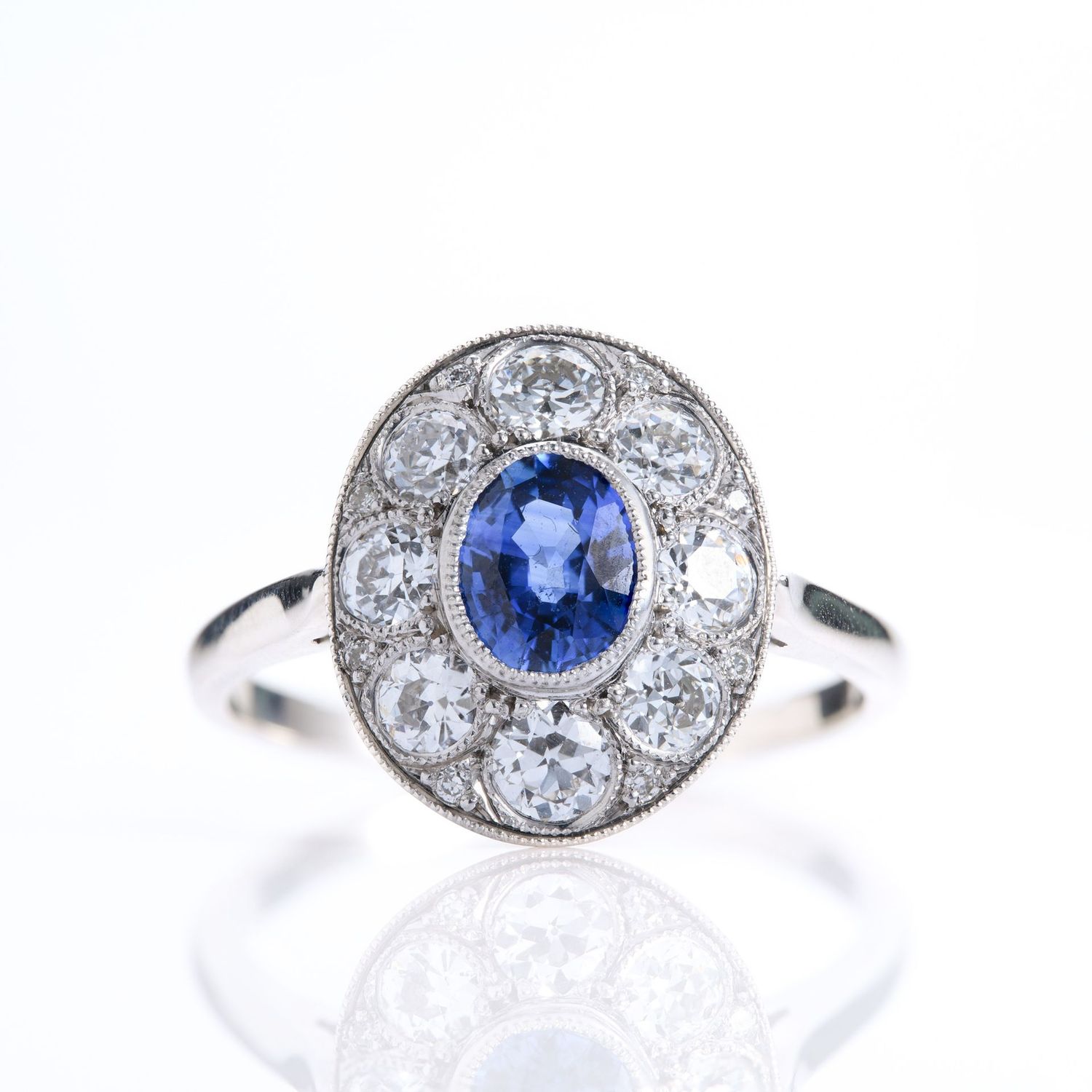 Pre-Loved 18ct White Gold Oval Cut Sapphire & Round Brilliant Cut Diamond Cluster Ring