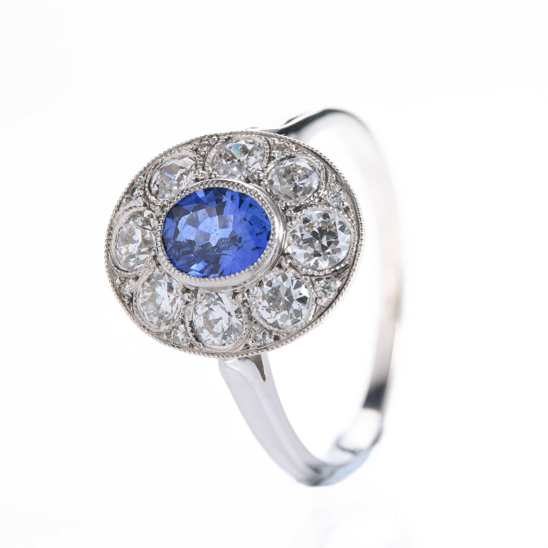 Pre-Loved 18ct White Gold Oval Cut Sapphire & Round Brilliant Cut Diamond Cluster Ring