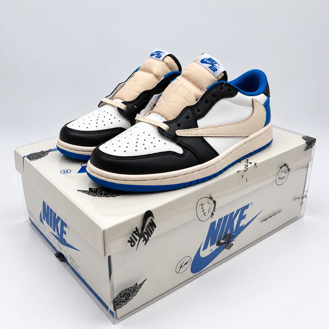 Travis Scott Fragment Jordan 1 Low replica sneakers in blue, white and black on their box