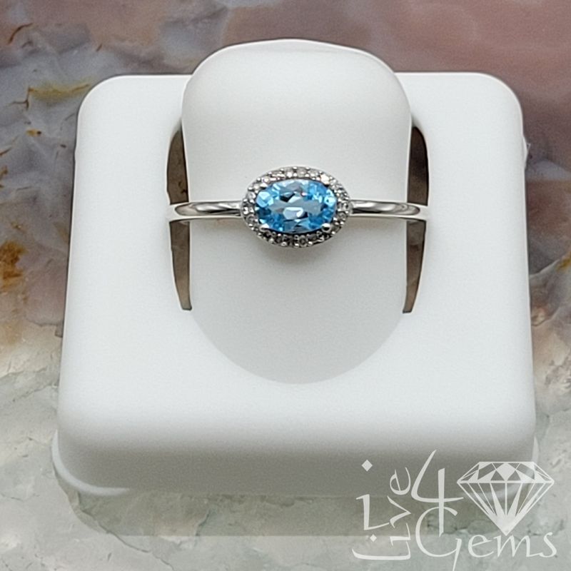 10ktw 0.1ctw Diamond Oval Blue Topaz Ring