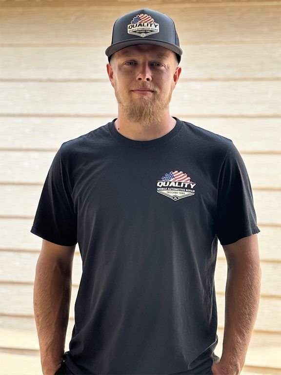 man wearing black t-shirt and hat with company logo
