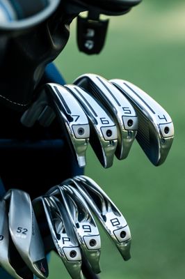 The set includes multiple irons, each with a sleek, polished design, ideal for a variety of shots on the golf course.