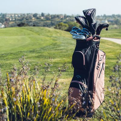 The set includes a variety of golf clubs, neatly arranged in a branded box, ideal for gifting or personal use.