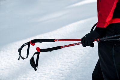 Pair of downhill ski poles with ergonomic grips and durable metal shafts, designed for stability and control.