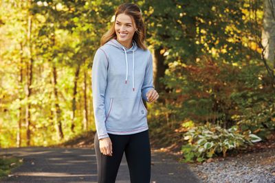 Cozy and stylish women&#39;s golf sweaters and hoodies, perfect for warmth and flexibility on the course.