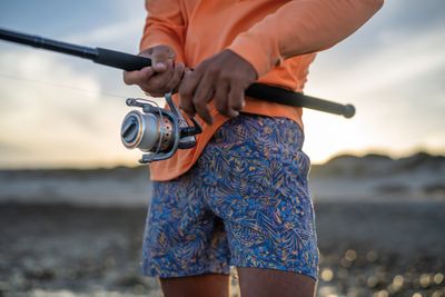 Men&#39;s swim trunks with a quick-dry fabric, elastic waistband, and drawstring, featuring a stylish design.