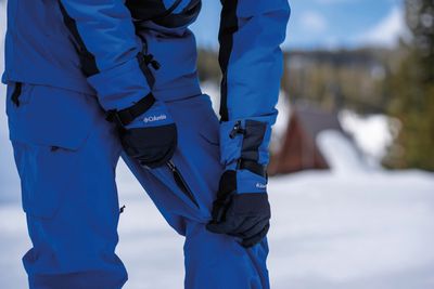 Men&#39;s waterproof, insulated snow pants with adjustable waist, reinforced knees, and multiple pockets for winter activities.