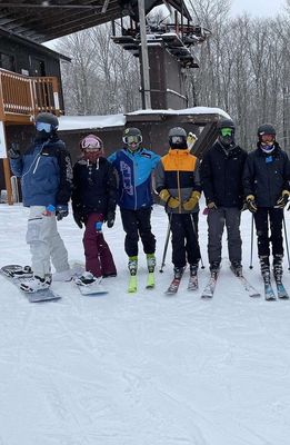Snow equipment including skis, snowboards, boots, and accessories for winter sports enthusiasts.