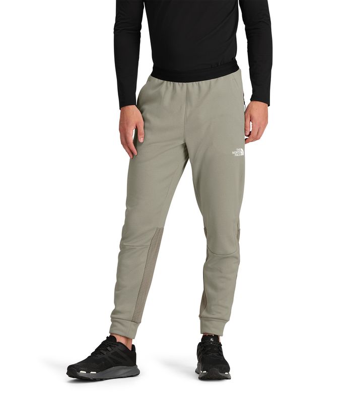 FRONT MODEL VIEW OF THE NORTH FACE MENS MOUNTAIN ATHLETICS FLEECE PANT WITH OPEN HAND POCKETS AND F…