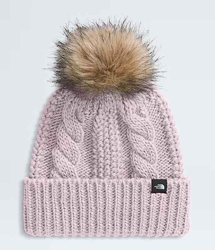 FRONT VIEW OF THE NORTH FACE YOUTH OH MEGA FUR POM BEANIE WINTER HAT FEATURES OVERSIZED FAUX FUR PO…