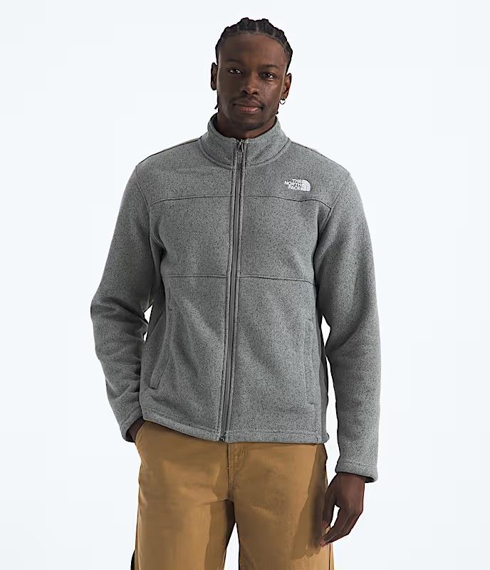 FRONT VIEW OF THE NORTH FACE MENS GORDON LYONS FULL ZIP SWEATER FEATURES SOFT FLEECE FABRIC AND SEC…