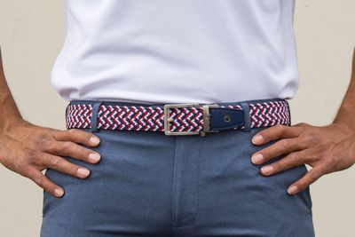 Men's golf belts feature adjustable buckles and are designed to provide comfort and a secure fit during play.