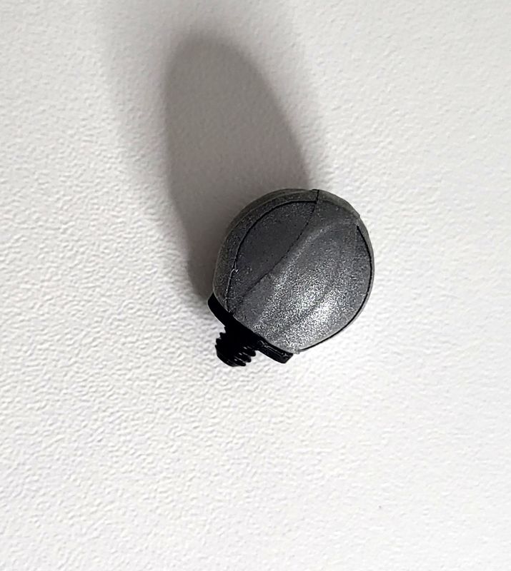 Top-down view of a 14mm motion capture cluster marker with an M4 screw in the center for attaching to a cluster plate. It may have reflective material for optical motion capture tracking