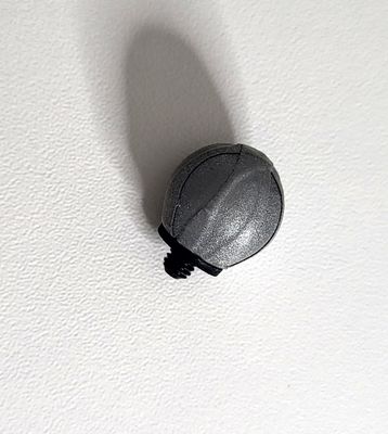 Top-down view of a 14mm motion capture cluster marker with an M4 screw in the center for attaching to a cluster plate. It may have reflective material for optical motion capture tracking