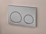 Plaque de commande double Geberit Alpha25 ronde, finition chrome mat, montage mural, design à deux boutons.