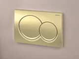 Plaque de chasse d'eau double ronde Geberit Alpha01 en laiton mat brossé avec mécanisme de déclenchement frontal et tiges insonorisées.