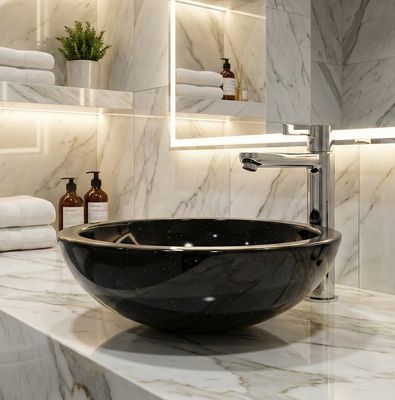 Bol à poser Bolero 44 cm granité noir Lavabo vasque en granit noir, Bolero 44 cm, accessoire de salle de bain moderne avec robinet argenté élégant installé.