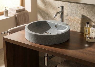 Évier en granit gris, Bol à poser Tempo 47 cm, sur un comptoir en bois avec robinet moderne.