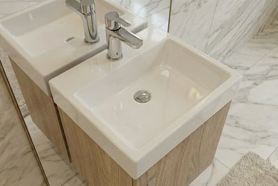 Lavabo Lave-mains Aden 35 cm, lavabo en céramique blanche avec robinet argenté et installation sur socle en bois.