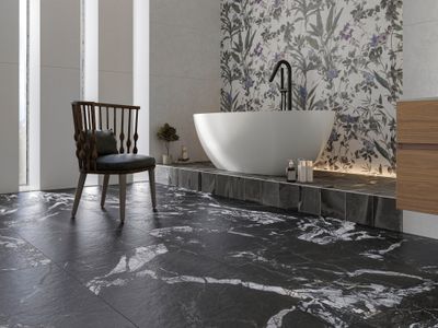 Carrelage en marbre noir veiné de blanc, intérieur de salle de bains moderne avec baignoire îlot et chaise en bois.