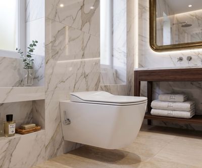 Toilettes blanches suspendues avec abattant à fermeture douce, fonction bidet et design moderne dans une salle de bains en marbre.
