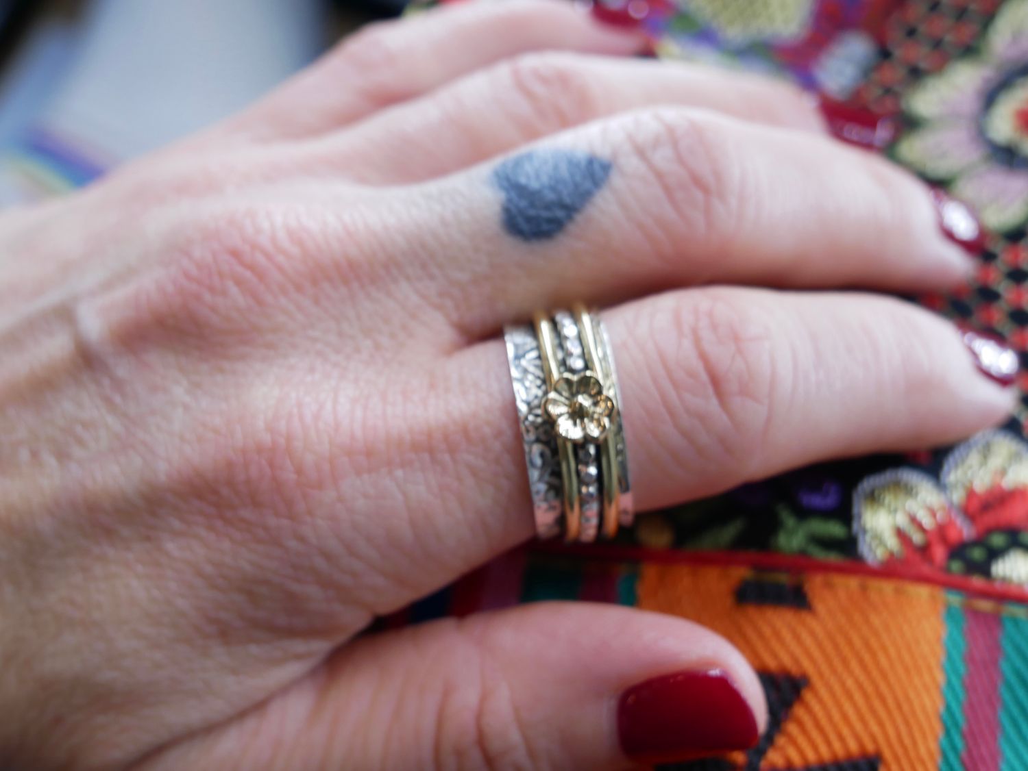 NADAIR  Silver ornate ring with flower detail with brass and silver bands