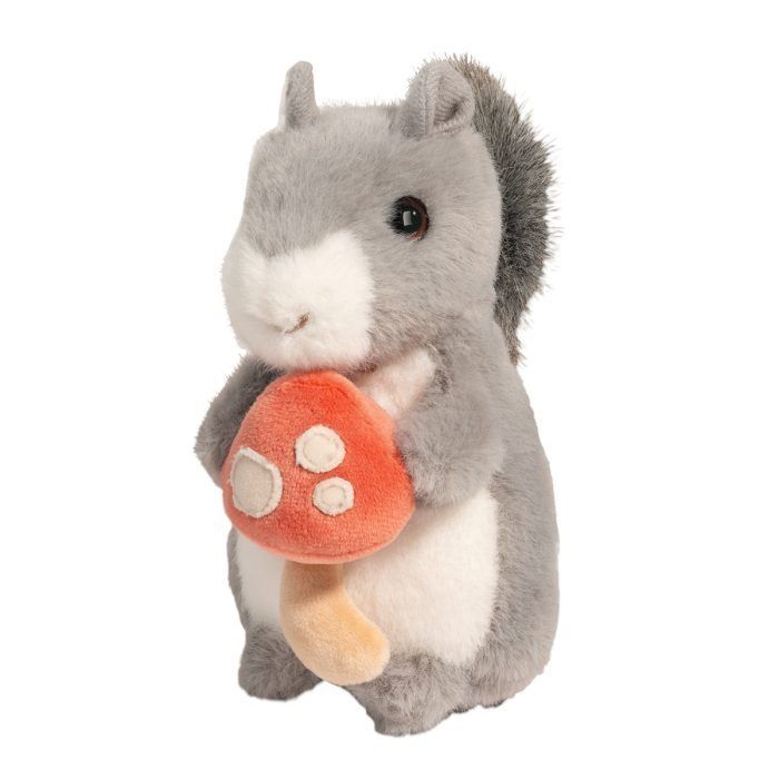 A stuffed squirrel with a cheerful expression holds a mushroom, highlighting its soft texture and whimsical design.
