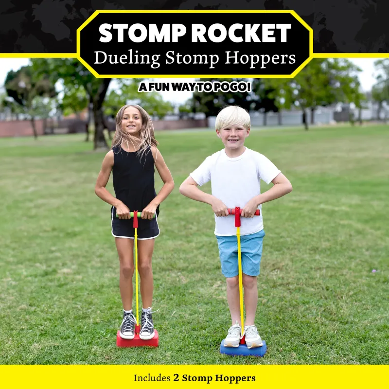 Two children standing on colorful stomp hoppers in a grassy park, ready for a fun game of dueling pogo.