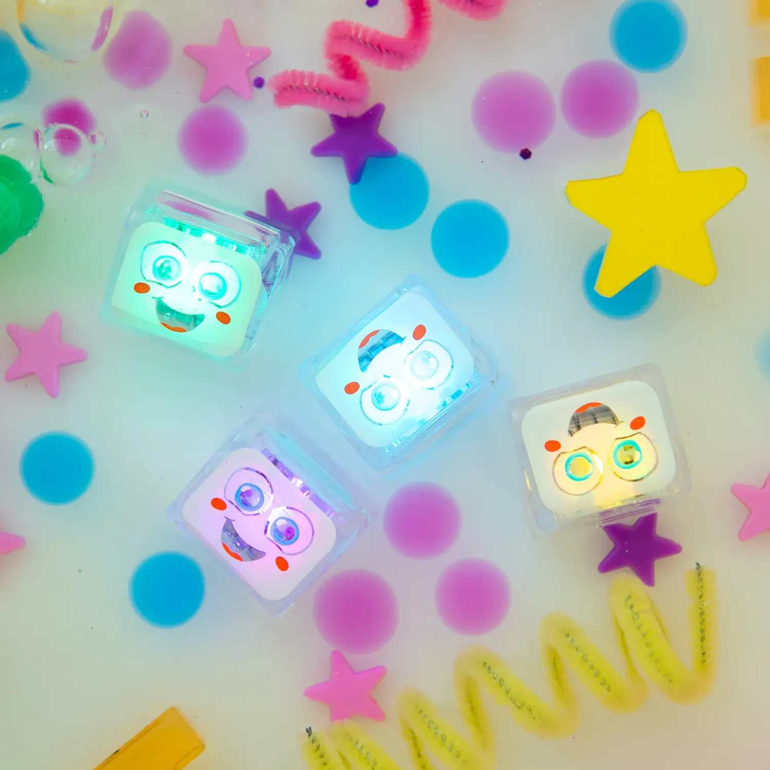 Four light up glo pals lit up in a bathtub.