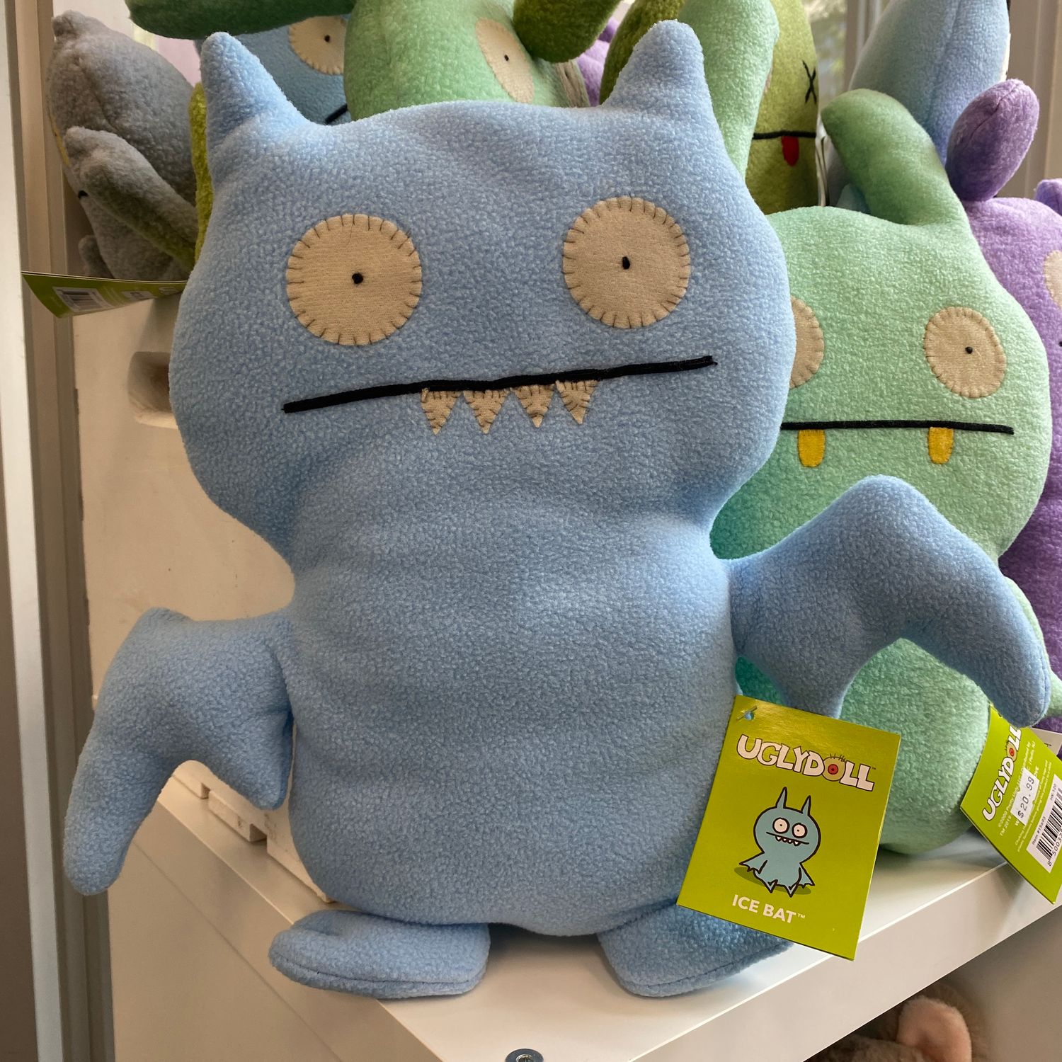 A light blue ice bat uglydoll with small sharp teeth.