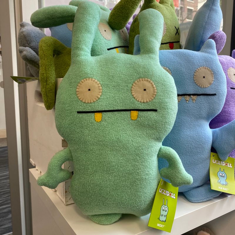 A minty green uglydoll names Moxy, with cute bunny ears and a stressed face.