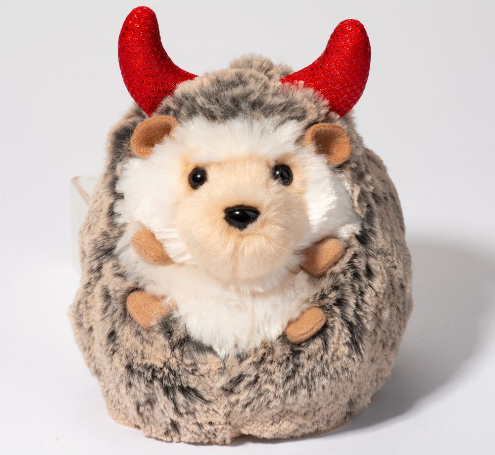 A small stuffed hedgehog named Spunky wearing little devil horns.