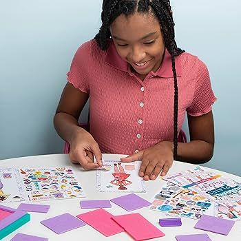 A young girl in pink playing with her My Style Fashion Plate set.