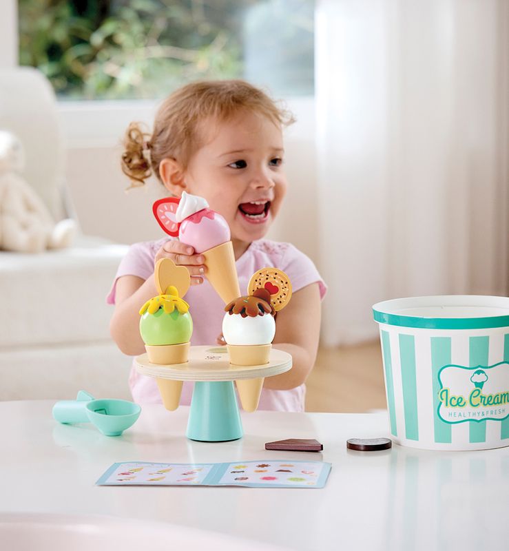 A cute kiddo playing with a colorful wooden ice cream set.