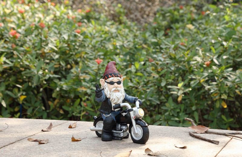 75616-W - GNOME W/PEACE SIGN RIDING MOTORCYCLE  / 9.25&quot; H