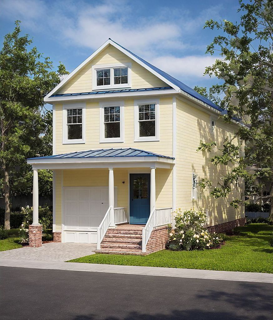 Exterior rendering of a narrow lot home plan with light yellow siding, covered front entry, and compact single-car garage.
