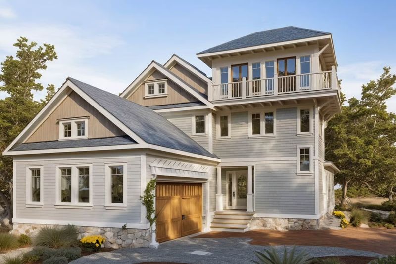 Exterior rendering of a traditional three-story home plan with side-entry garage, dormer windows, and classic front porch.
