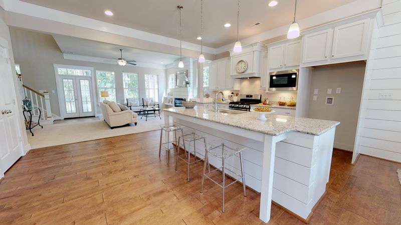 Kitchen concept image for The Magnolia 311 plan with island and cabinetry