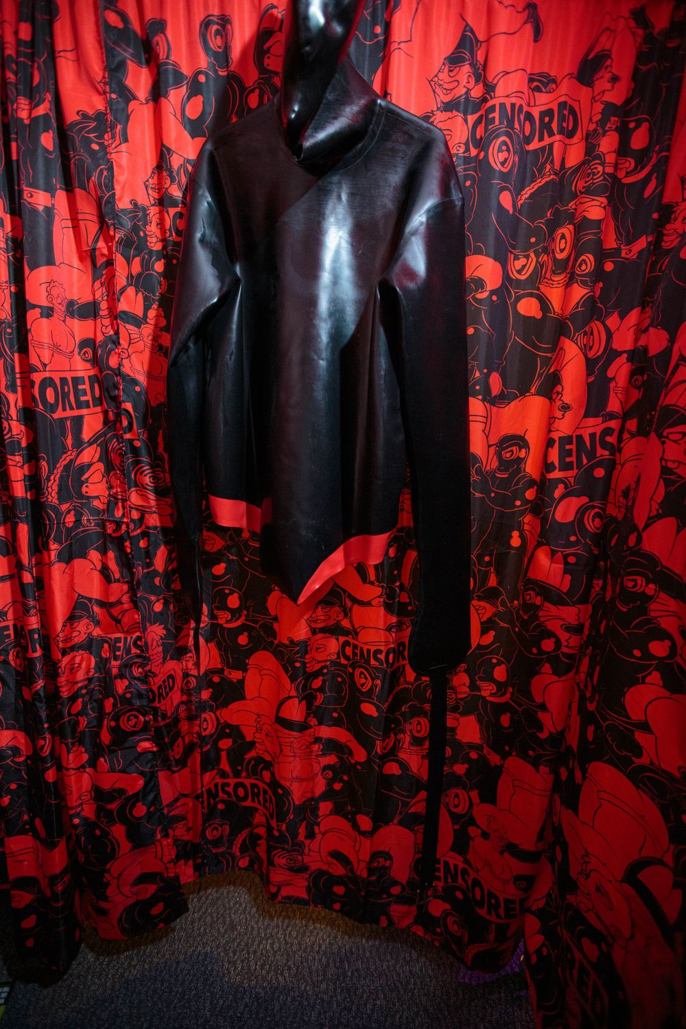 Latex straightjacket with attached hood