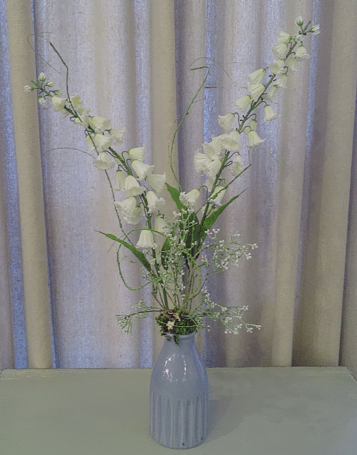 White floral in blue vase