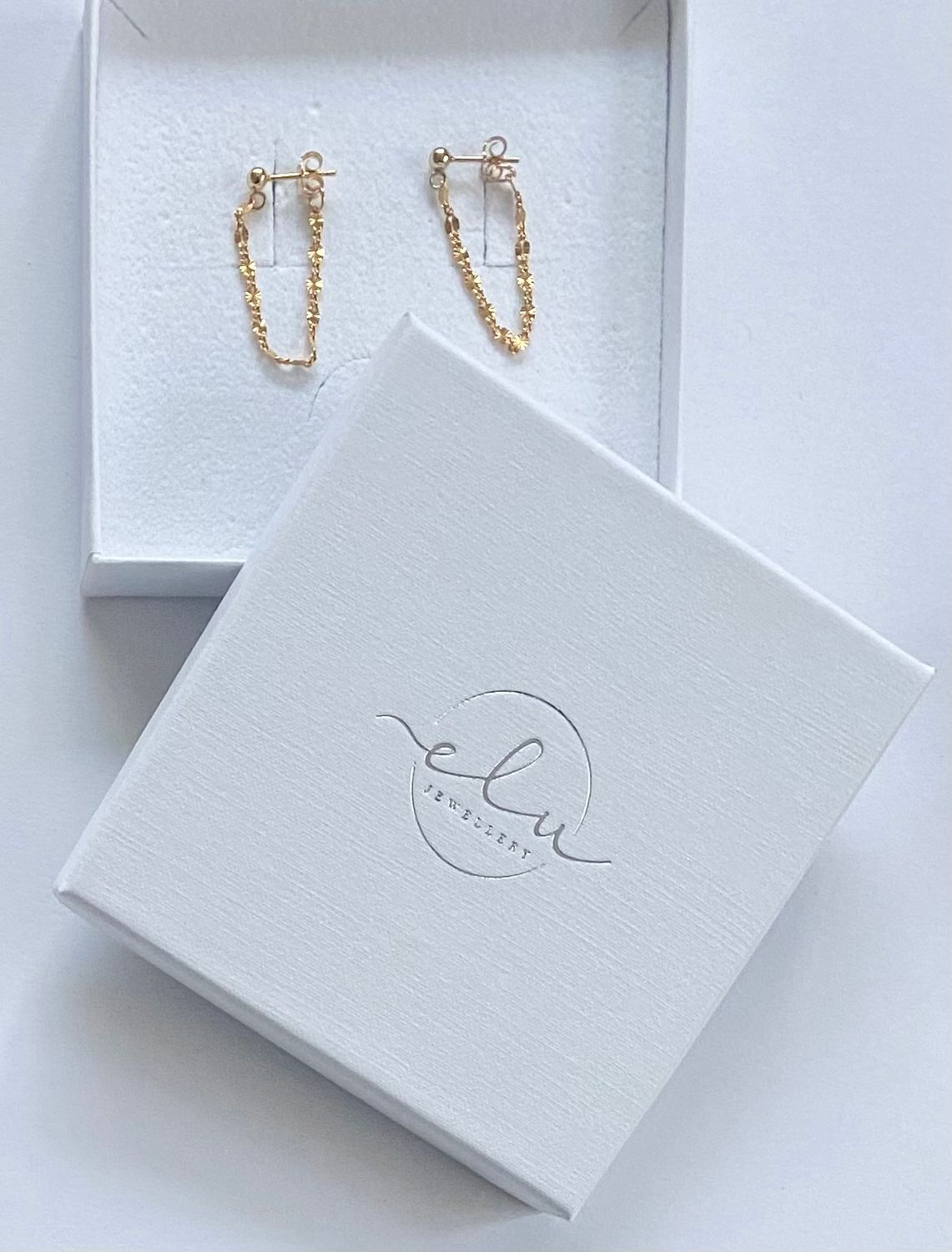 Gold starburst chain earrings