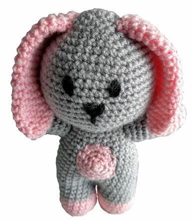 A grey and pink crocheted rabbit toy.