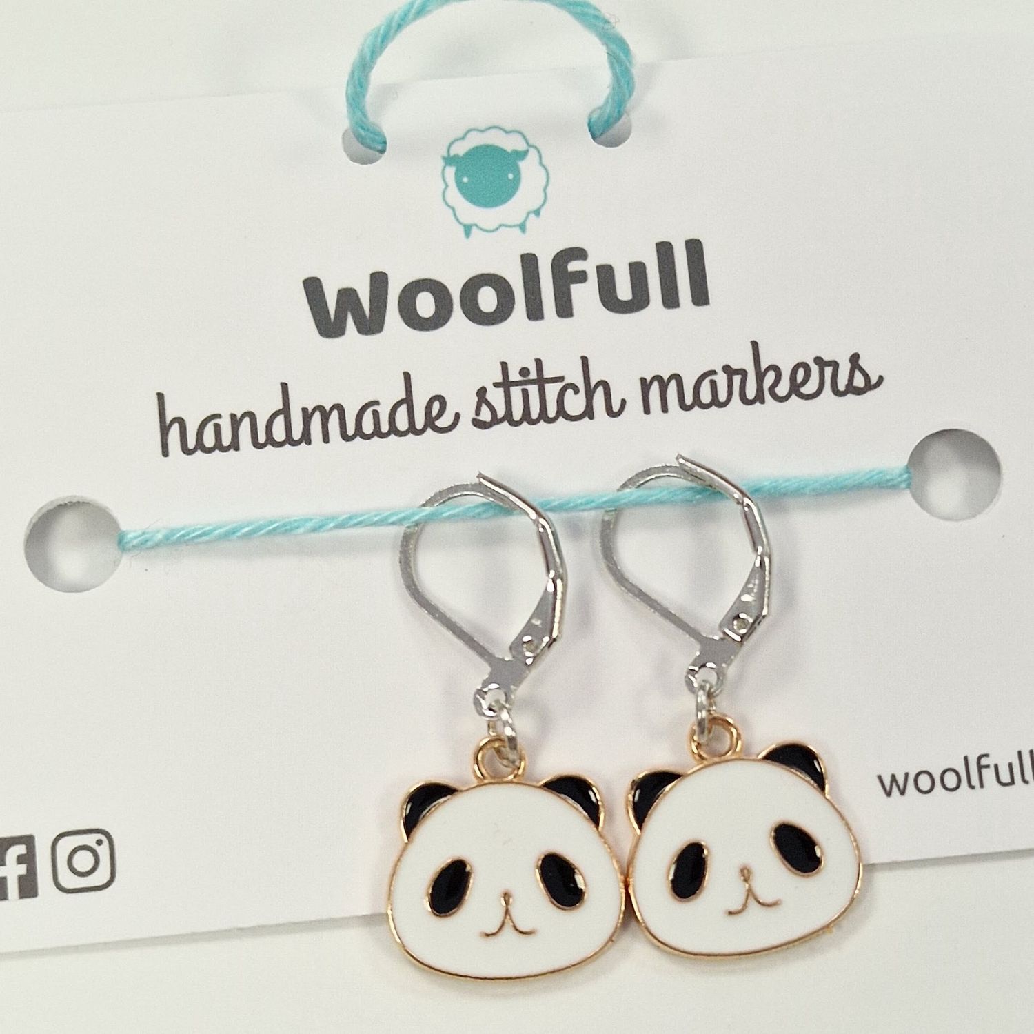 2 black and white panda face shaped stitch markers.